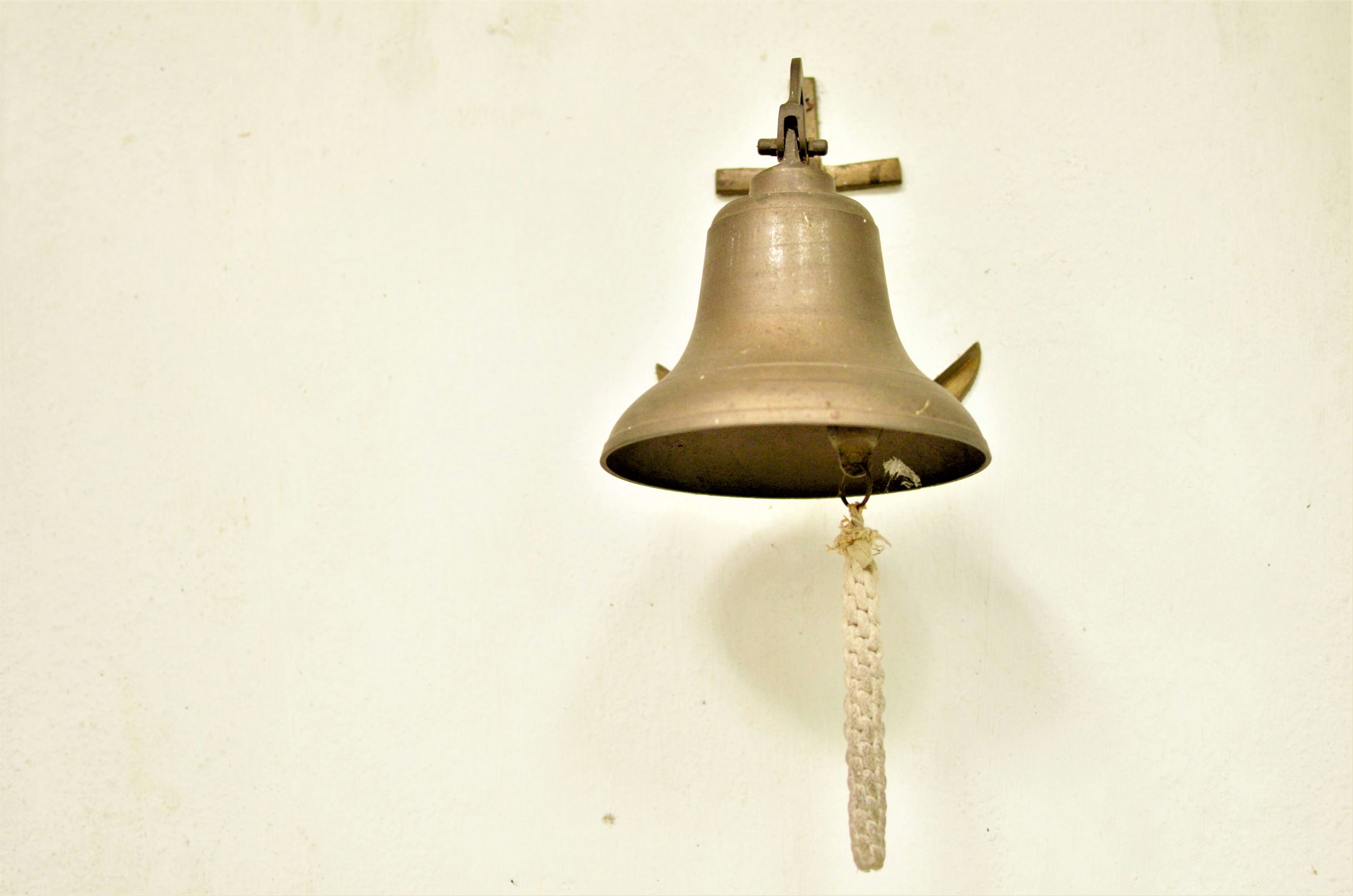 brass bell on a wall