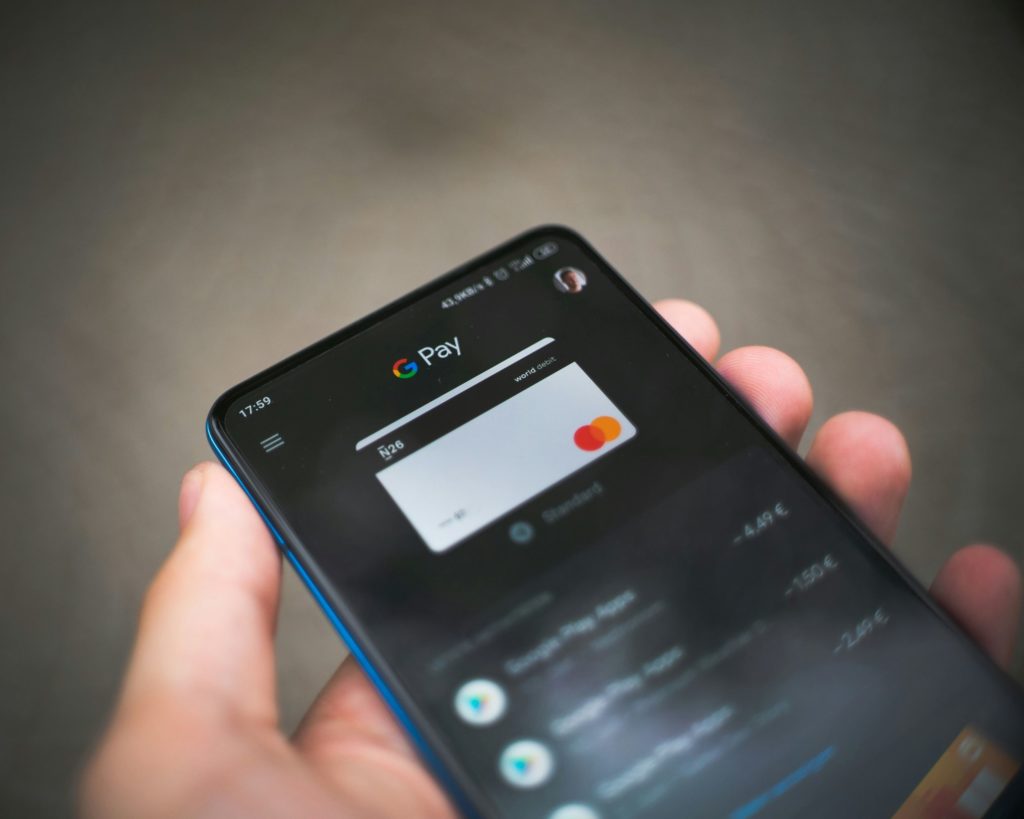 hand holding smartphone showing google pay screen