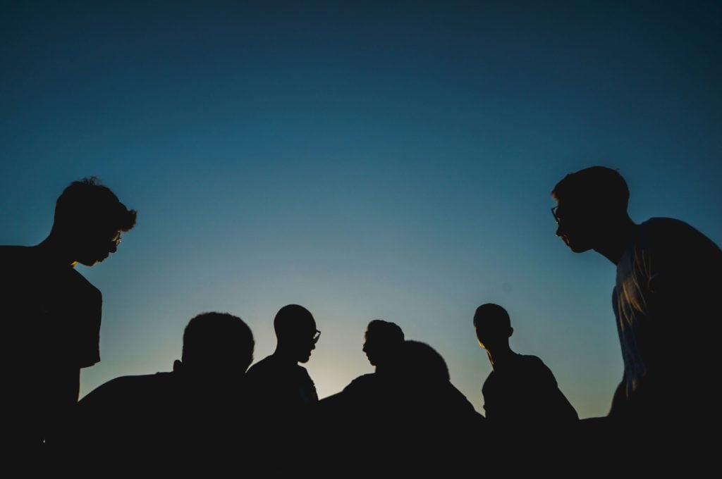 group of people at dusk