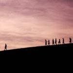 leading a group hike at dusk