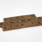 Scrabble tiles that spell "People remember stories"