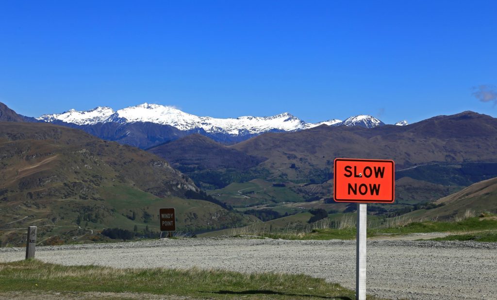 slow now sign in front of mountain view