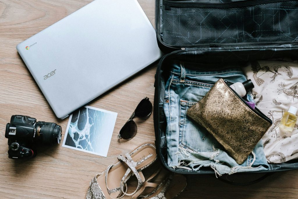 travel bag with camera, laptop and sandals