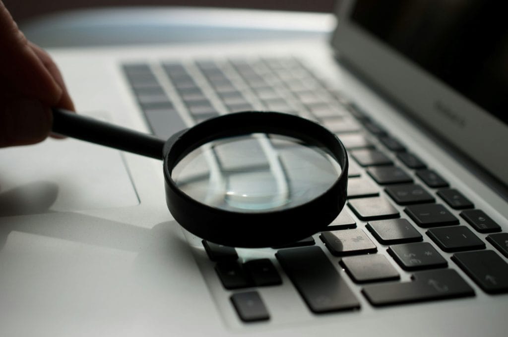 magnifying glass over laptop