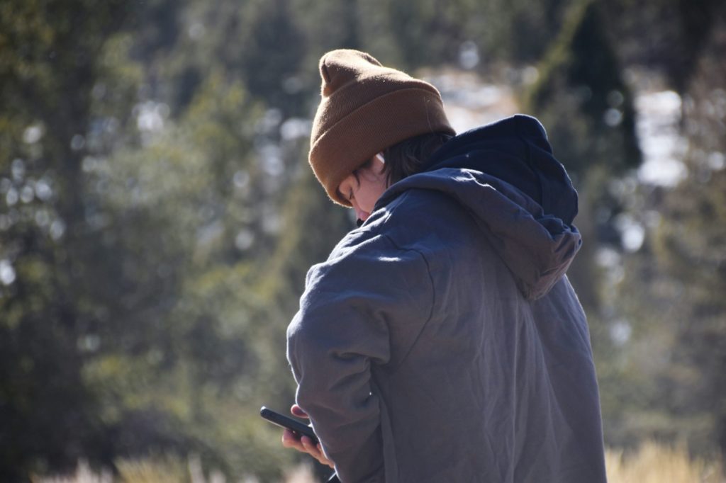 person looking at smartphone outdoors