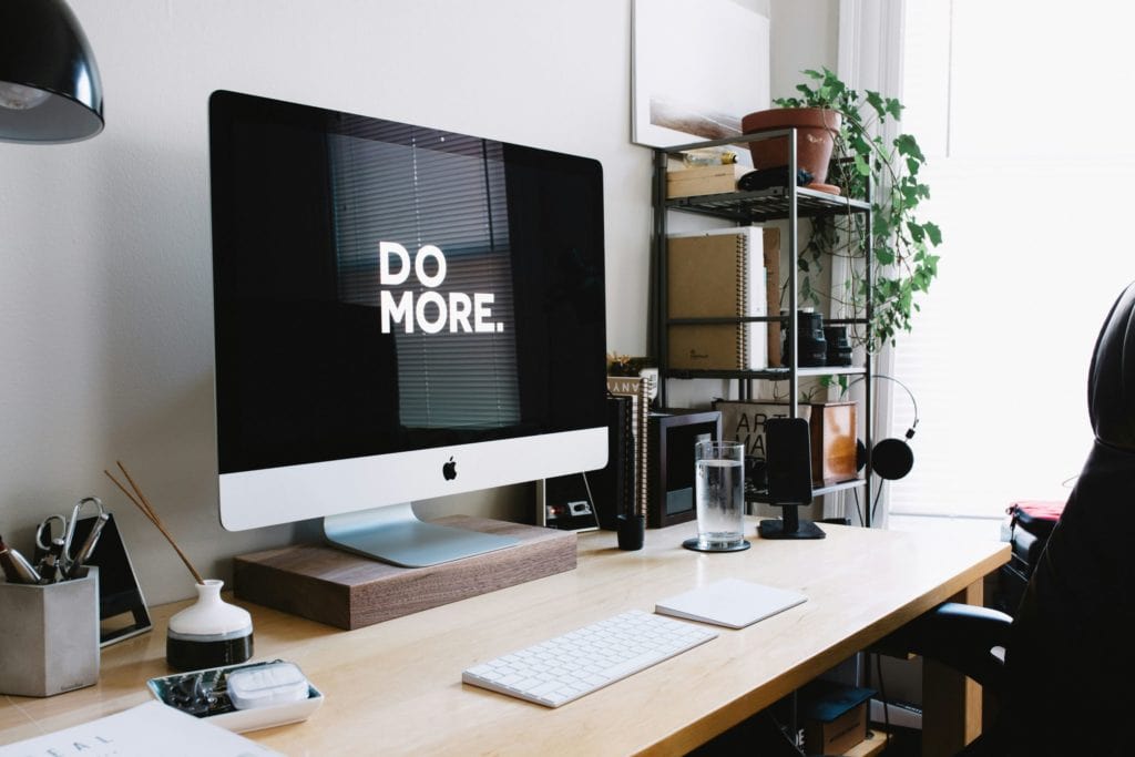 desk with computer that says "do more."