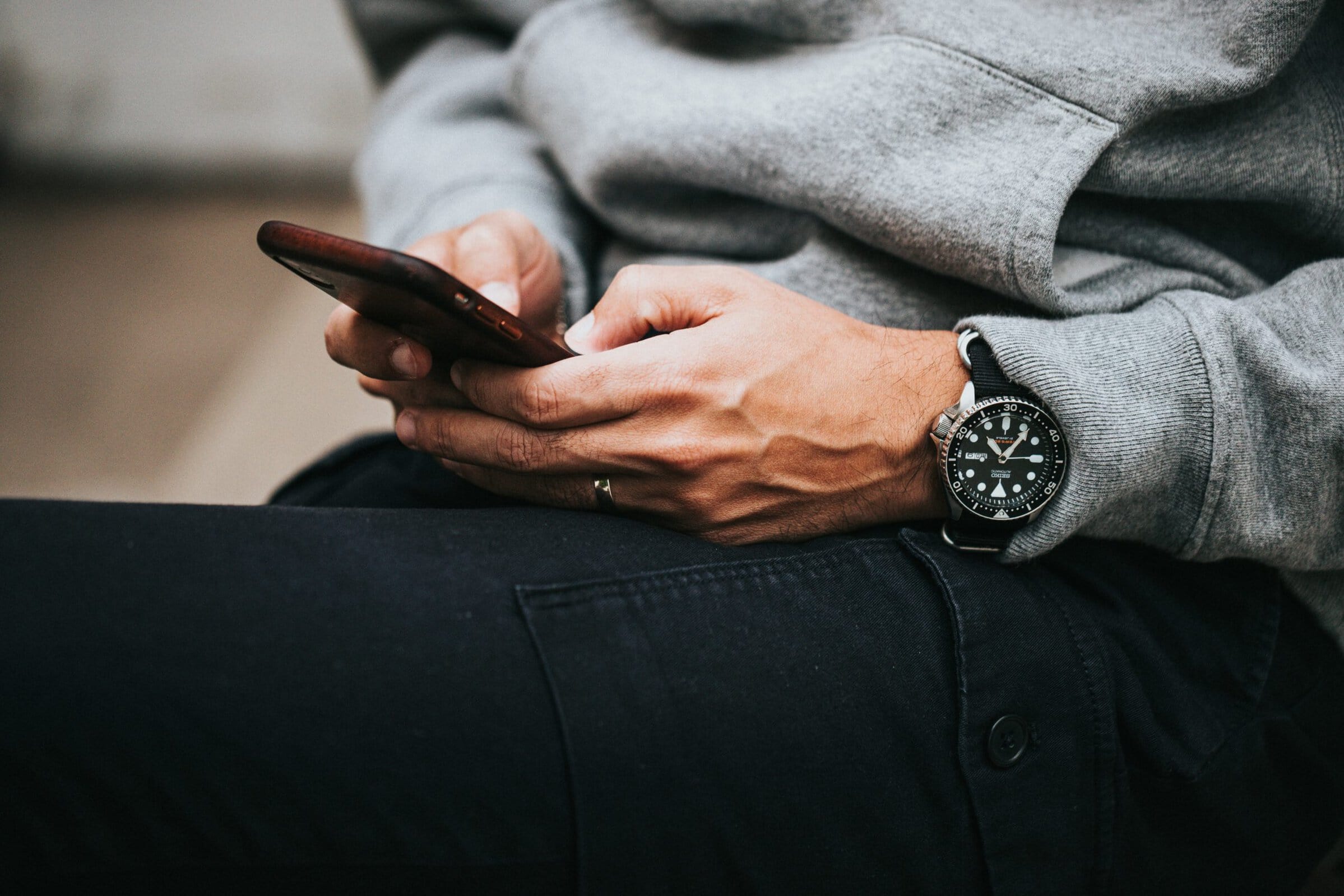 hands texting on a phone