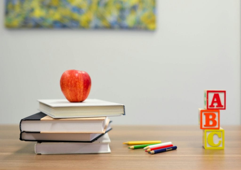 apple on books on school desk