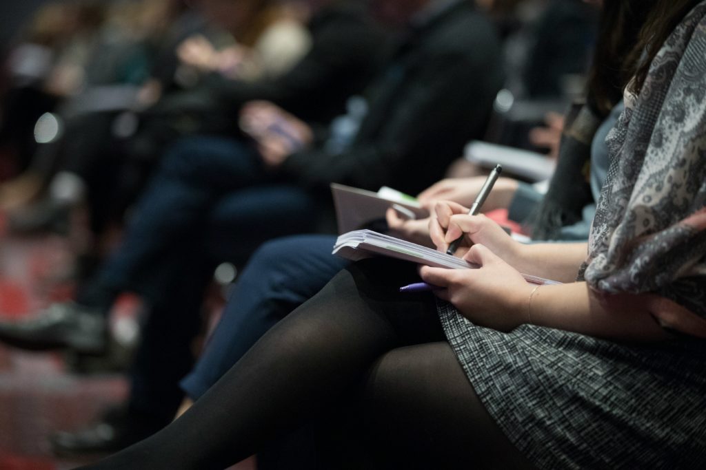 conference attendees taking notes