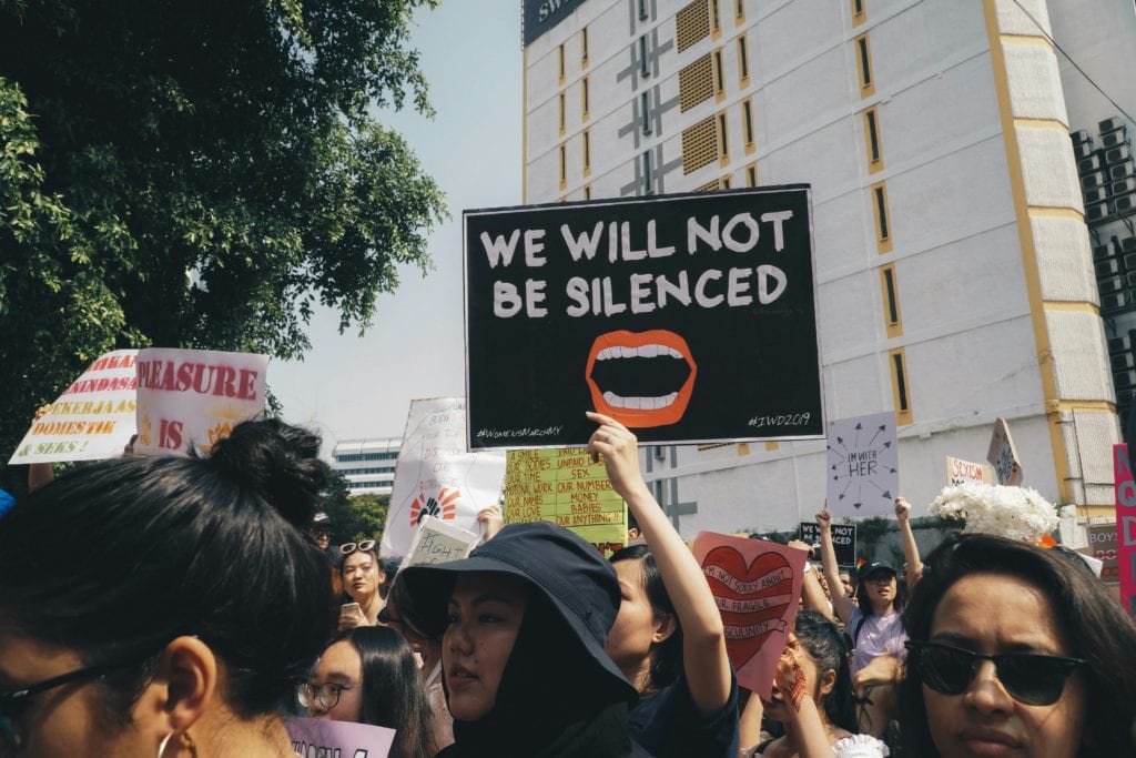 protest sign that says "we will not be silenced"