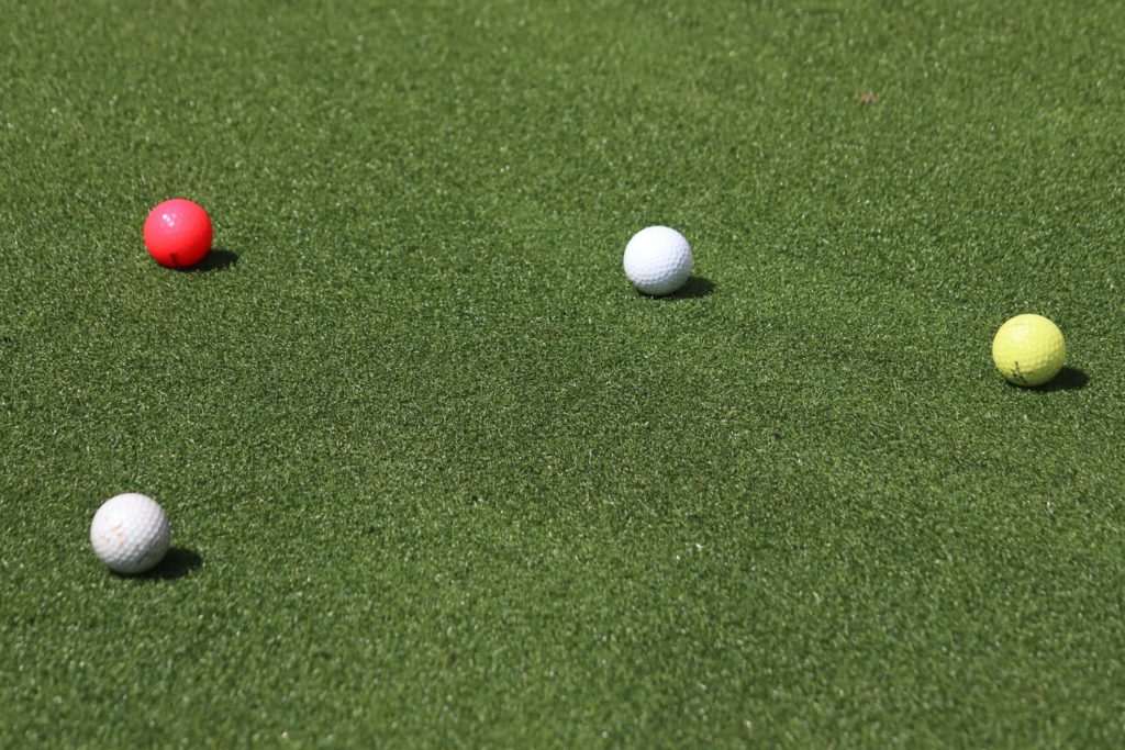 colorful golf balls on green