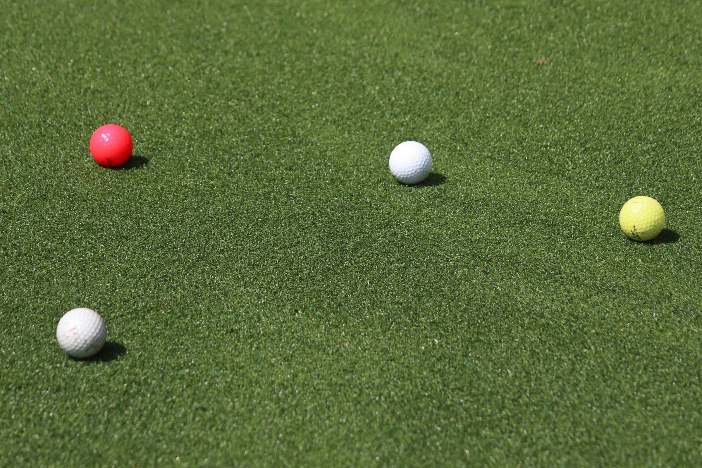 colorful golf balls on green