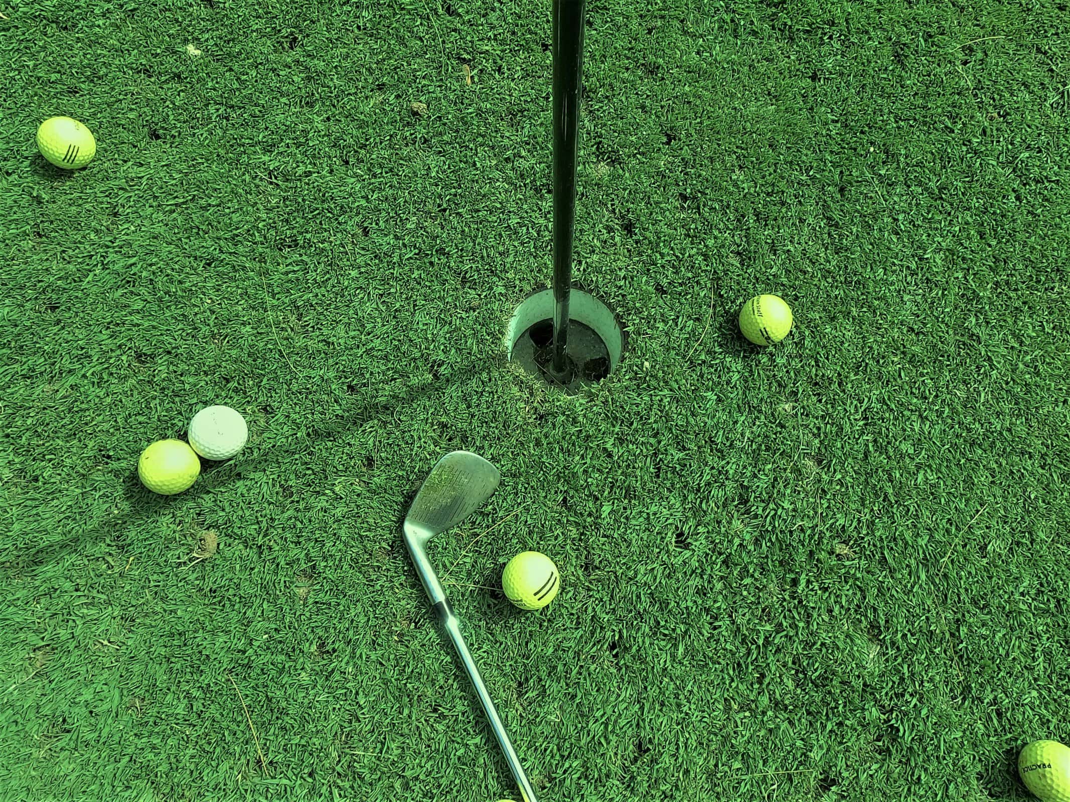 golf balls near hole